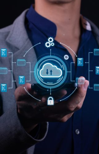 Vertical Photo of A man employs cloud-based computing on his smartphone to facilitate data transmission, storage, backup, and access